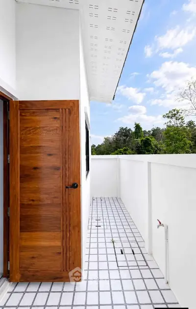 Charming balcony with wooden door and scenic view, perfect for relaxation.