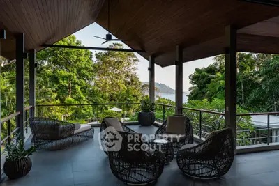 Stunning outdoor terrace with lush greenery and ocean view, perfect for relaxation and entertaining.