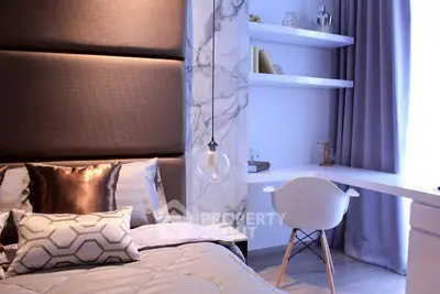 Luxurious modern bedroom with elegant decor and stylish workspace.