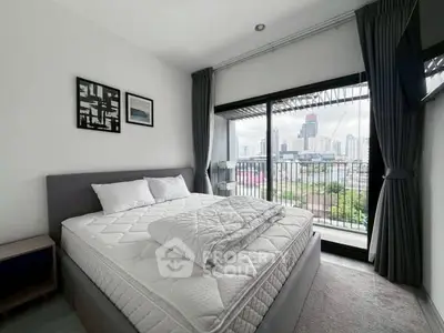 Modern bedroom with city view and large windows in urban apartment.