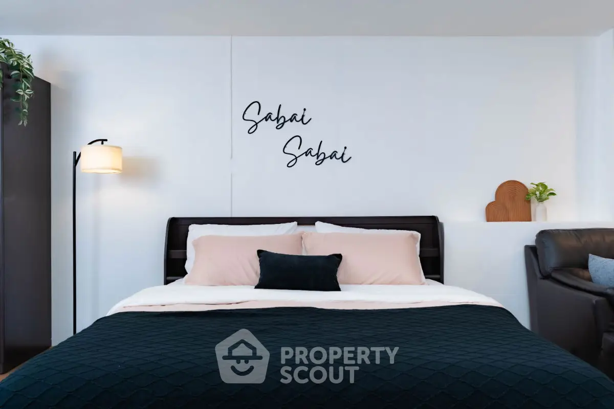 Cozy bedroom with stylish decor and comfortable bedding