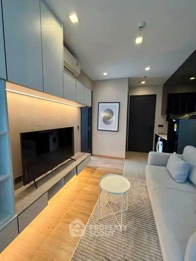 Modern living room with sleek design, featuring built-in storage, cozy sofa, and stylish decor.