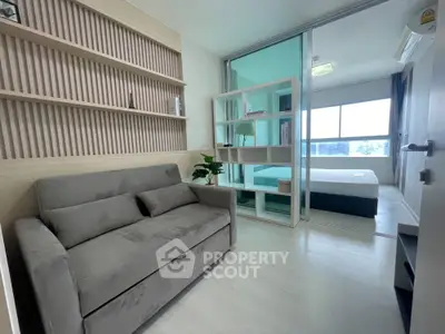 Modern apartment with cozy living room and bedroom, featuring stylish decor and ample natural light.