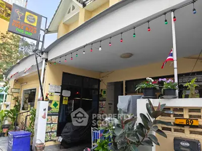 Charming exterior of a local establishment with festive lights and inviting entrance.