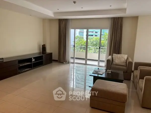 Spacious living room with modern furniture and balcony view