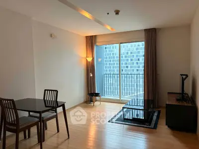 Modern living room with wooden flooring, dining set, and balcony view in a high-rise apartment.