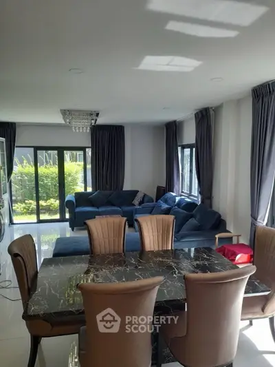 Spacious living room with elegant dining area and garden view