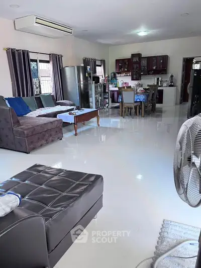 Spacious open-plan living and dining area with modern furnishings and ample natural light.
