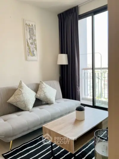 Modern living room with stylish sofa, chic decor, and balcony view in urban apartment.