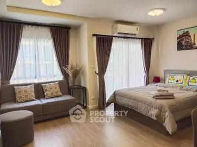 Spacious bedroom with modern decor and natural light in a cozy apartment