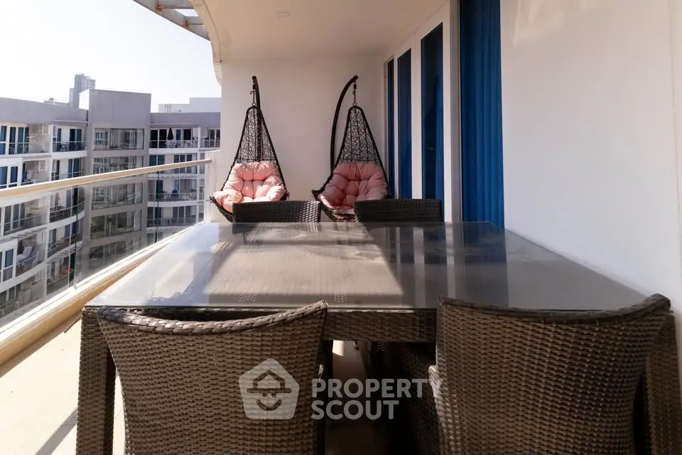 Spacious balcony with modern furniture and city view, perfect for relaxation and entertaining.