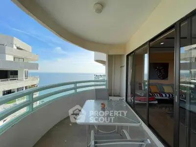 Stunning ocean view from spacious balcony with modern outdoor seating.
