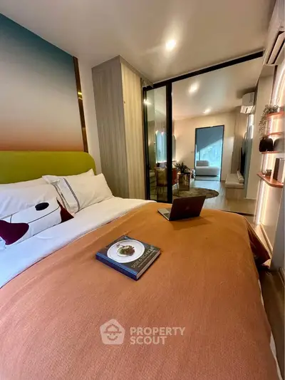 Cozy bedroom with modern decor and workspace, perfect for relaxation and productivity.