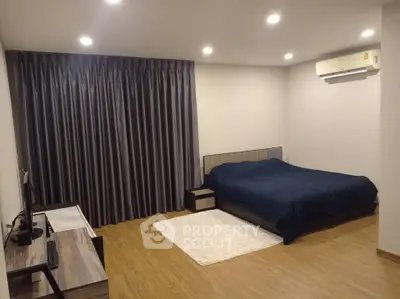 Spacious modern bedroom with elegant decor and cozy ambiance