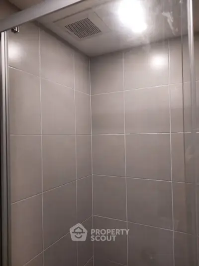 Modern bathroom shower with sleek tile design and glass enclosure