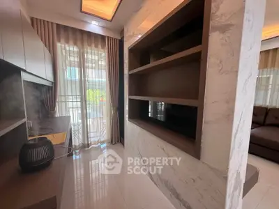 Modern living room with elegant shelving and large windows offering natural light.