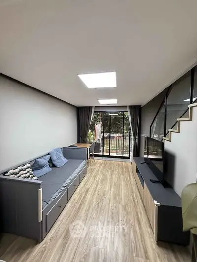 Modern living room with sleek design, large windows, and stylish furniture, perfect for relaxation and entertainment.