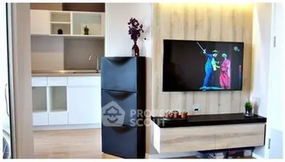 Modern living room with wall-mounted TV and sleek kitchen design