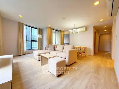 Spacious modern living room with elegant decor and natural light in a luxury apartment.