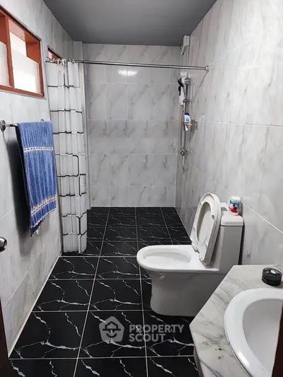 Spacious bathroom with modern fixtures and elegant tile design