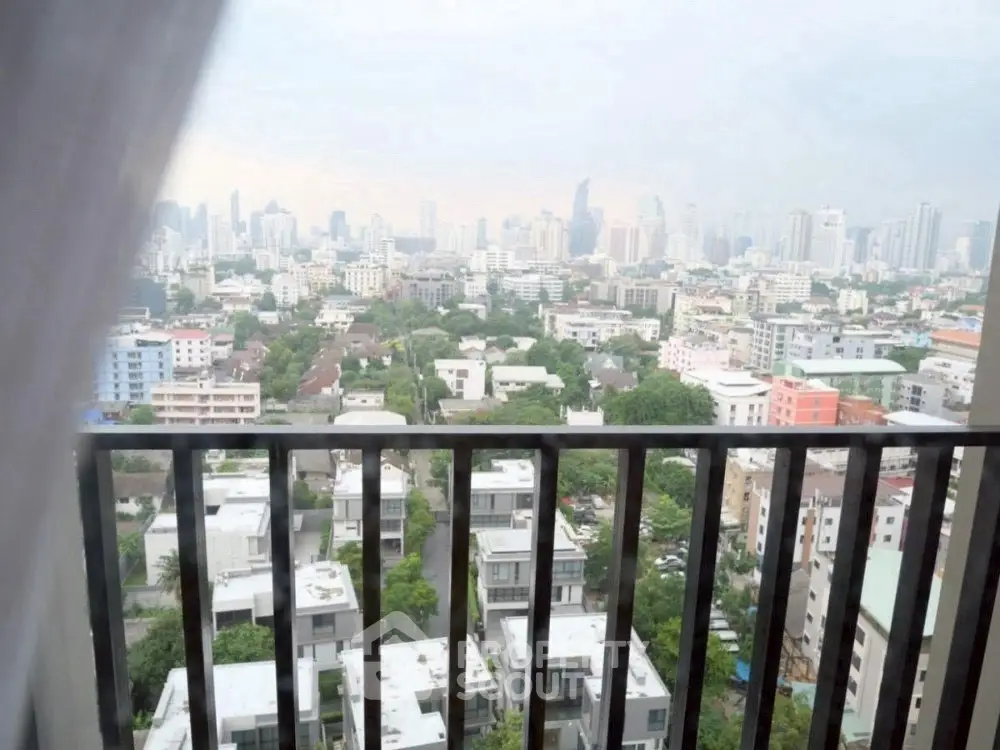 Stunning cityscape view from high-rise balcony overlooking urban skyline.