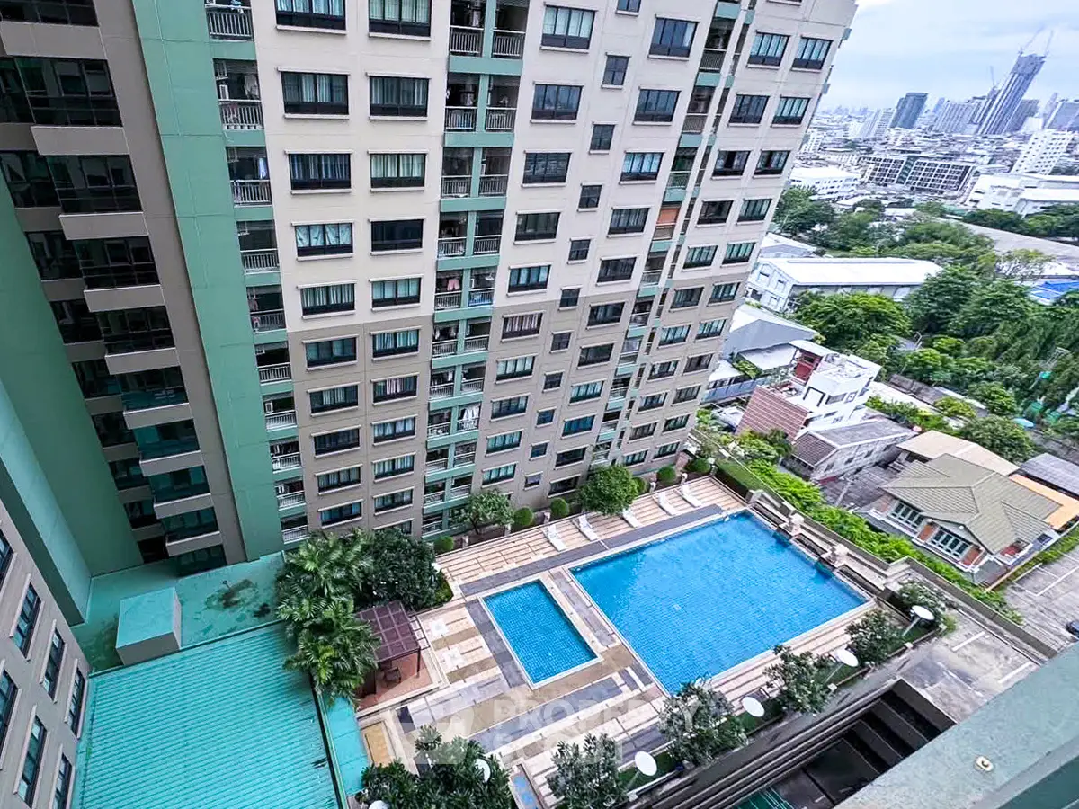High-rise building with a stunning pool view in a vibrant urban setting.
