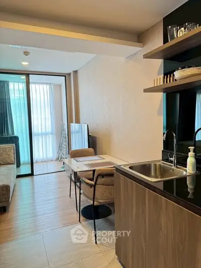 Modern open-plan living room with kitchenette and stylish decor