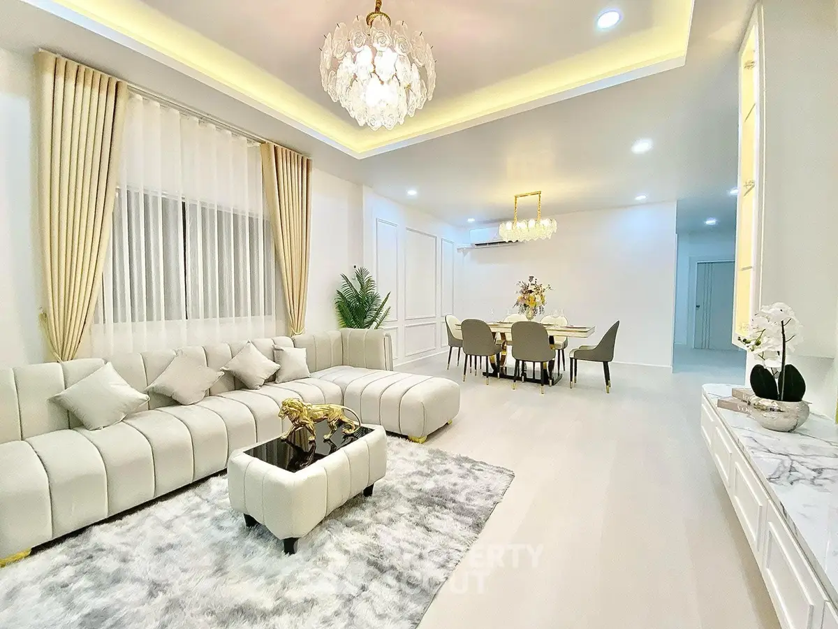 Luxurious living room with elegant chandelier and plush seating