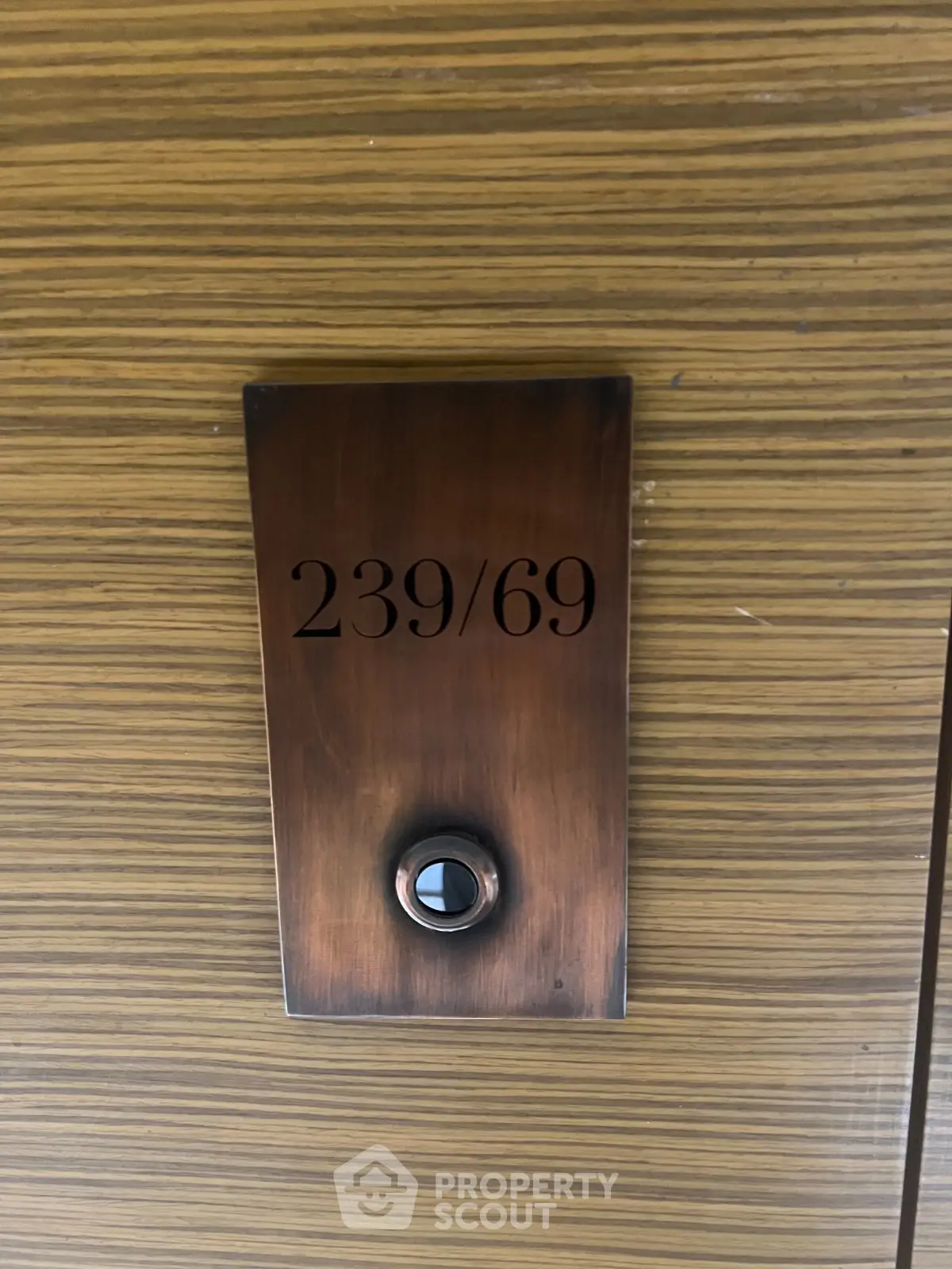 Stylish doorbell with modern wood paneling and sleek design, perfect for contemporary homes.