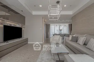 Modern living room with elegant decor and spacious layout, featuring neutral tones and stylish lighting.