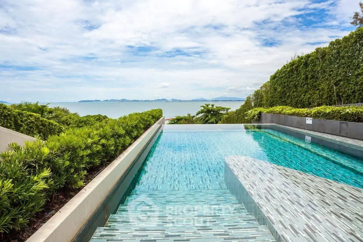 Luxurious infinity pool with stunning ocean view and lush greenery