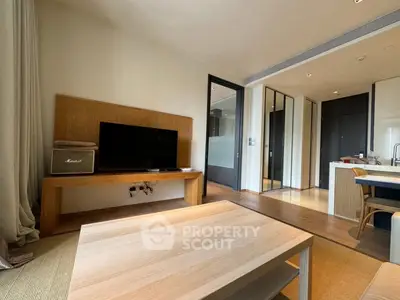 Modern living room with sleek wooden furniture and open kitchen layout