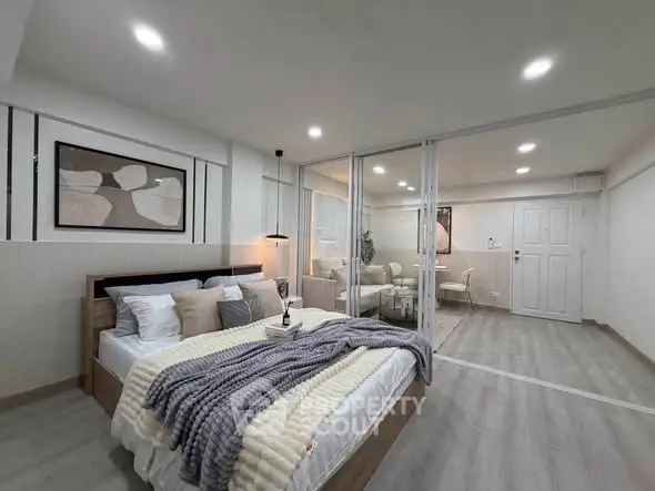 Modern bedroom with stylish decor and cozy ambiance in a contemporary apartment.