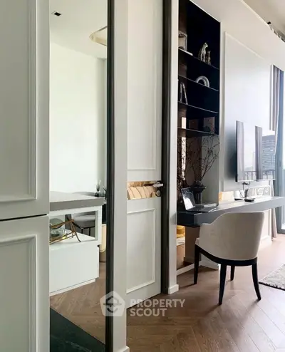 Stylish modern living room with sleek furniture and large windows offering city views.