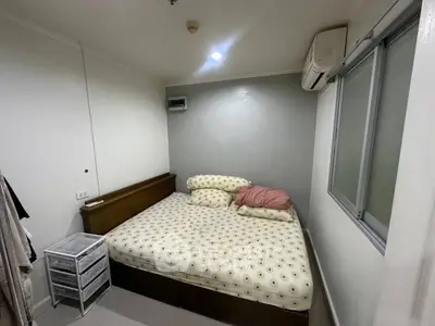 Cozy bedroom with air conditioning and modern decor in a compact space.