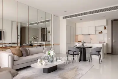 Luxurious modern living room with open kitchen, elegant decor, and mirrored wall accents.
