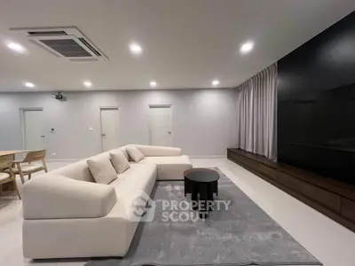 Spacious modern living room with sleek furniture and ambient lighting