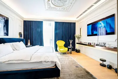 Luxurious bedroom with elegant decor, featuring a large bed, stylish furniture, and a wall-mounted TV.