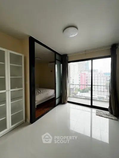 Spacious modern apartment with glass-walled bedroom and city view balcony.