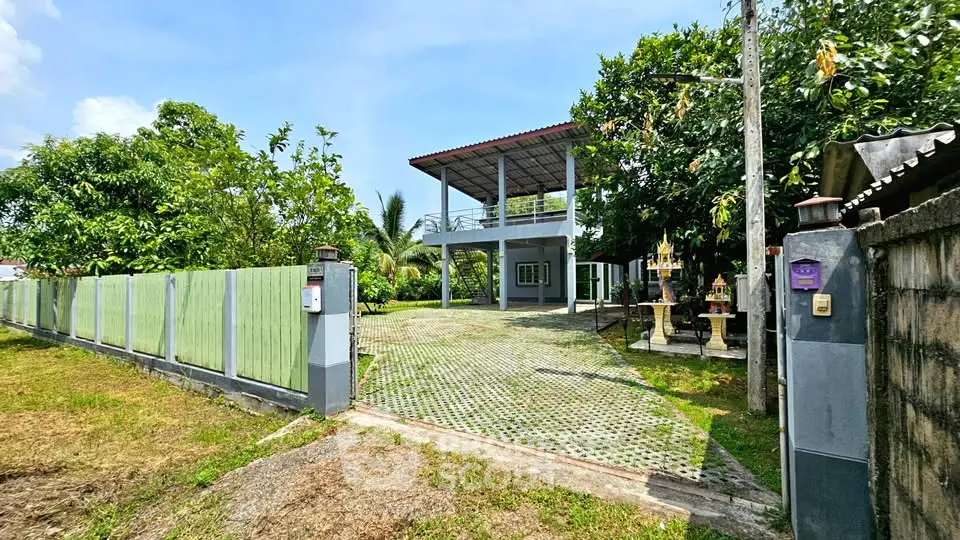 Spacious two-story home with lush garden and ample parking space, perfect for family living.