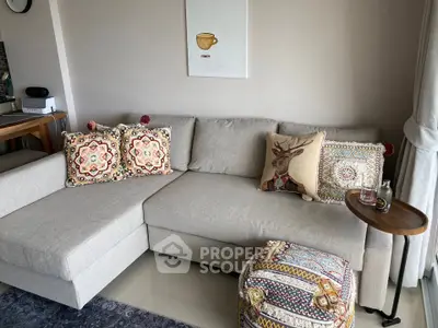 Cozy living room with stylish sectional sofa and decorative cushions, perfect for relaxation and entertaining.