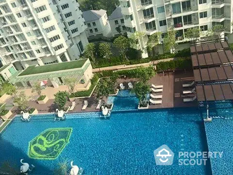 Luxurious condominium with stunning pool and lush garden view