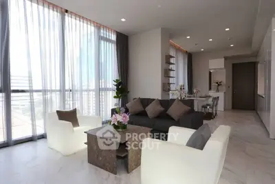 Luxurious modern living room with elegant decor and large windows