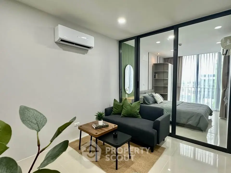 Modern living room with sleek design and cozy bedroom view