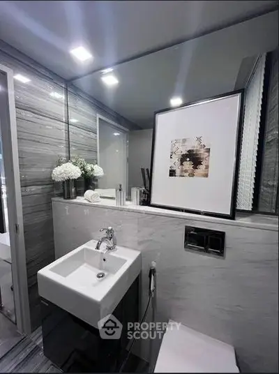 Modern bathroom with sleek design, featuring a stylish sink and elegant decor.