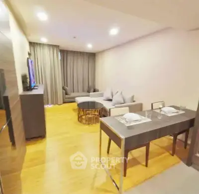 Modern living room with dining area, stylish furniture, and warm lighting in a cozy apartment.