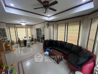 Spacious living room with modern decor and large windows for natural light.