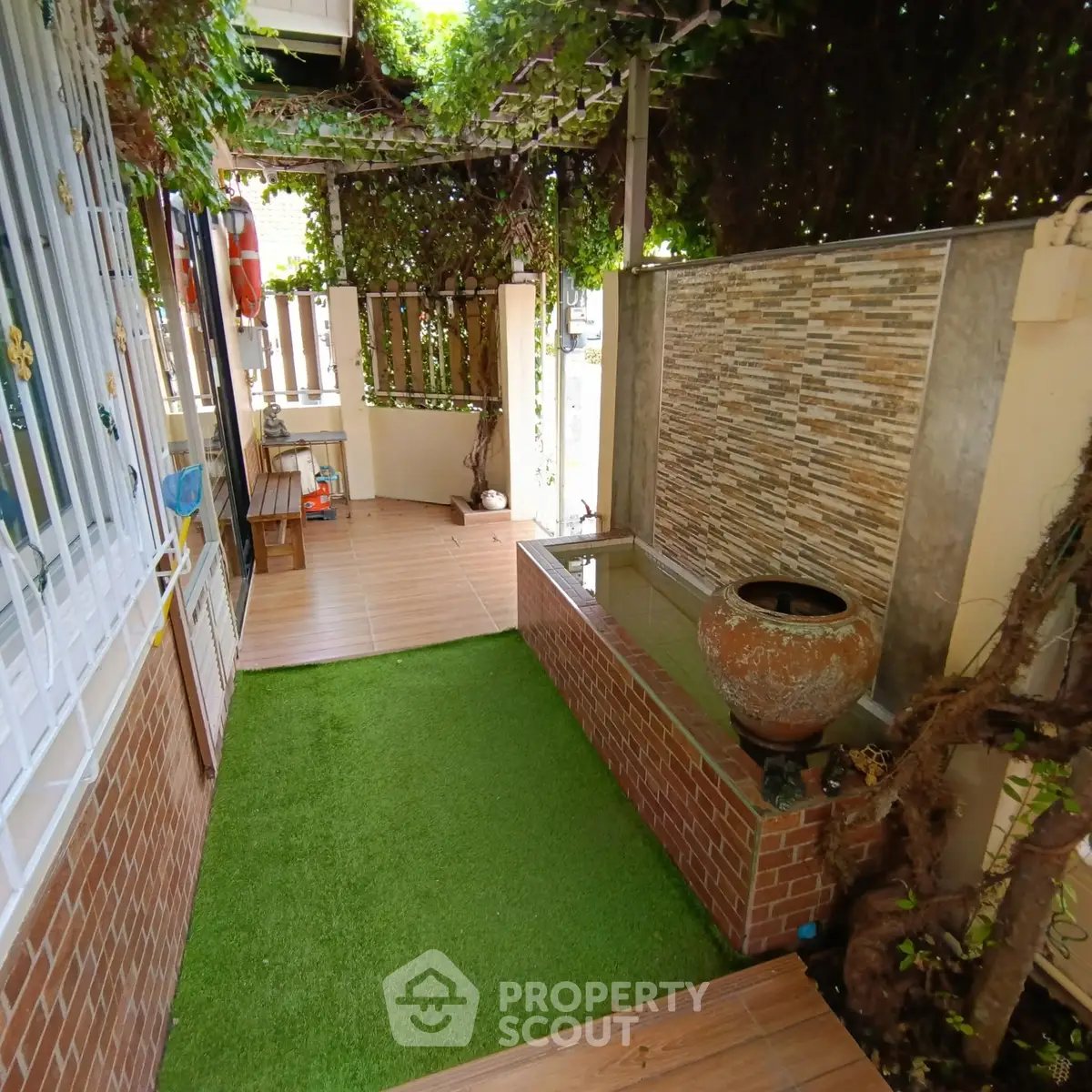 Charming garden area with lush greenery and decorative water feature