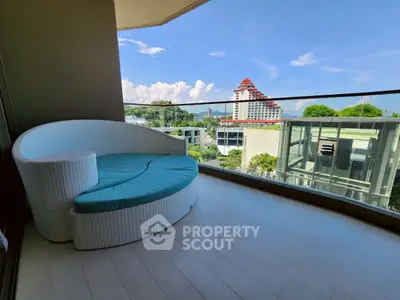 Spacious balcony with modern seating and stunning city view