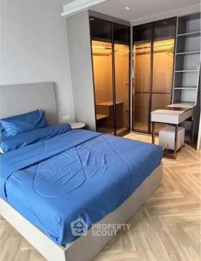 Modern bedroom with stylish blue bedding and spacious walk-in closet